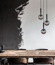 TRATTINO: Interior Bronze Amber / Smokey Black Spherical Glass Multiple Round Base Pendant Lights
