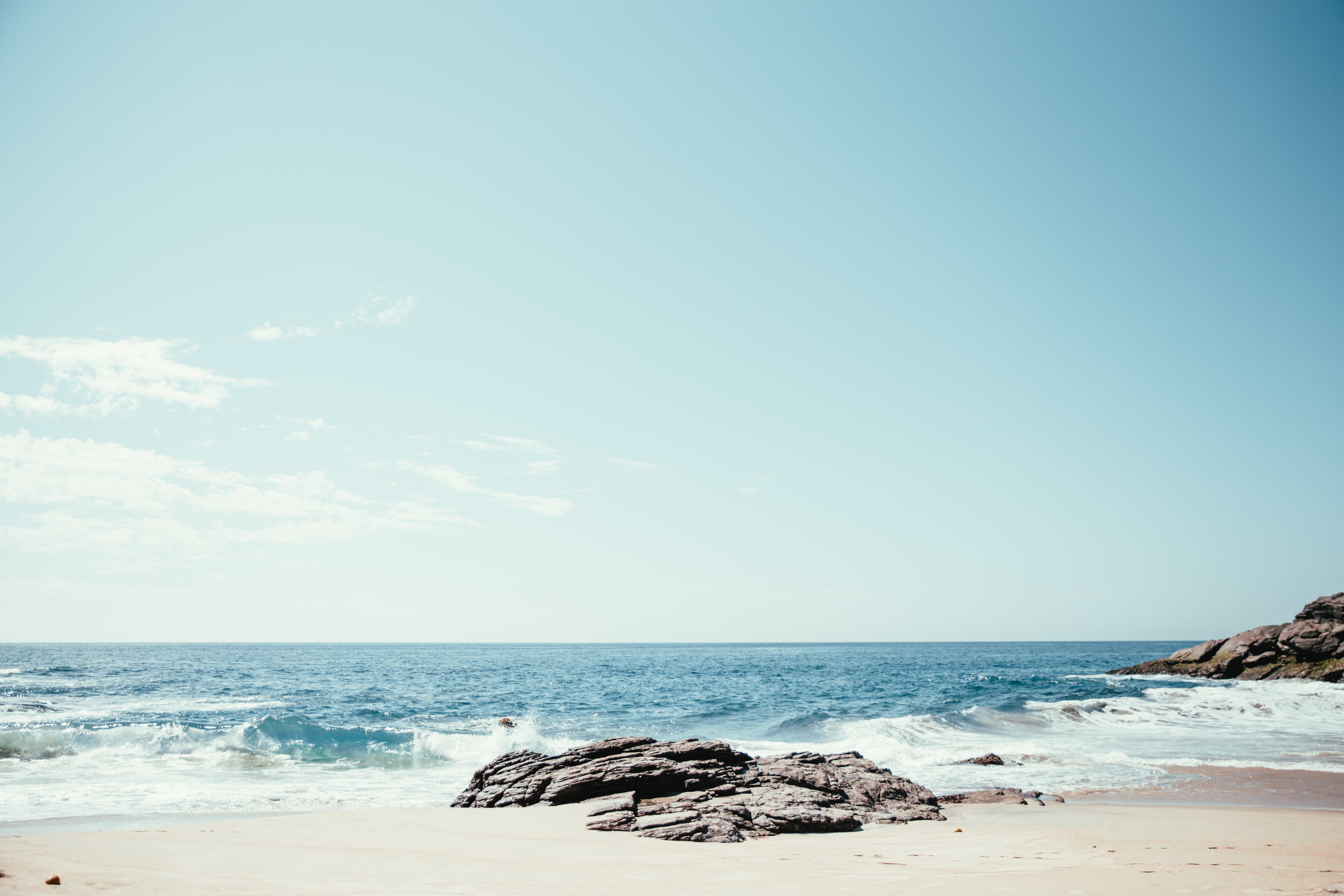 waves-crash-on-rocks-and-sand.jpg